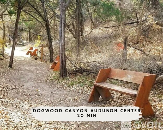 A sign in front of a wooded area reads "Dogwood Canyon Audubon Center 20 min.".