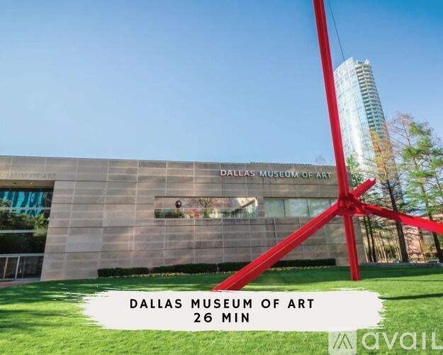 The Dallas Museum of Art is a modern building with a large red sculpture in front.