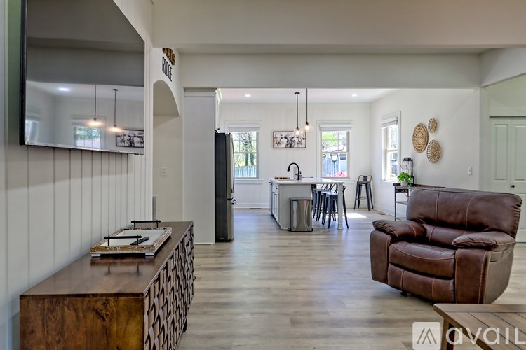 A living room with a brown leather chair and a wooden coffee table.