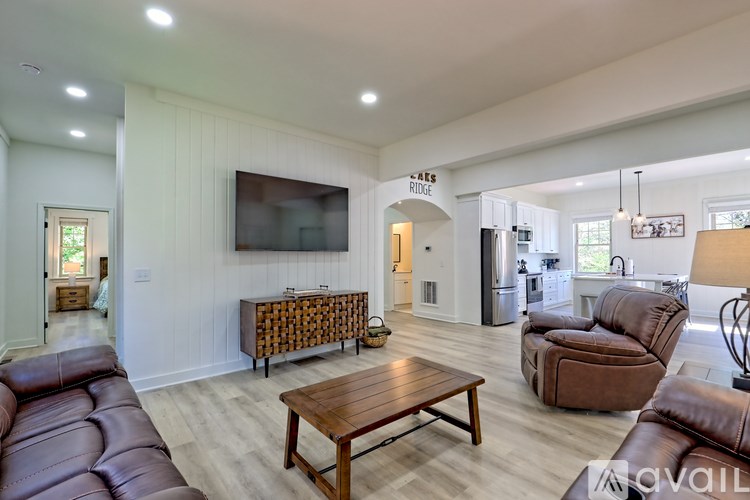 A living room with a brown leather couch and a wooden coffee table.