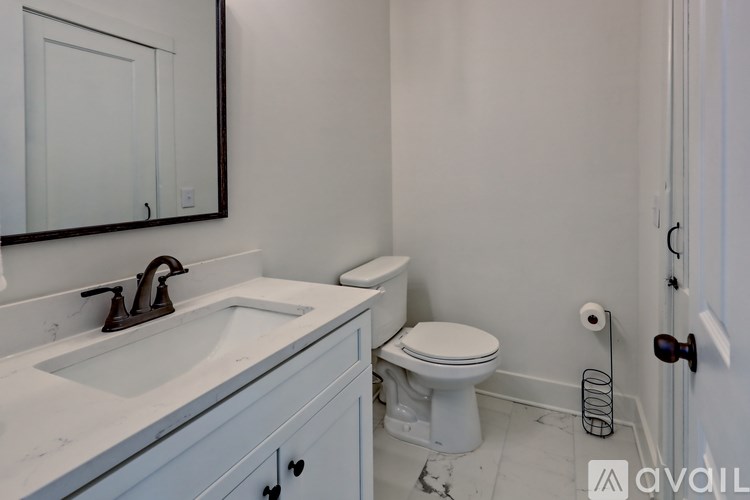 A white toilet sits next to a sink in a bathroom.