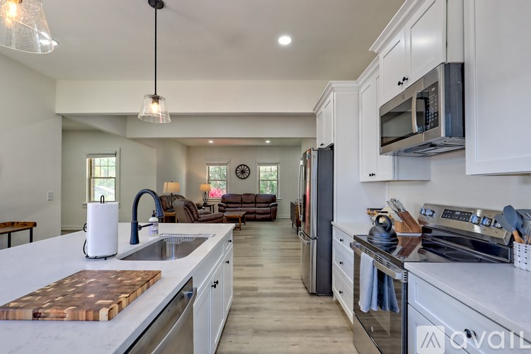A modern kitchen with stainless steel appliances and white cabinets.