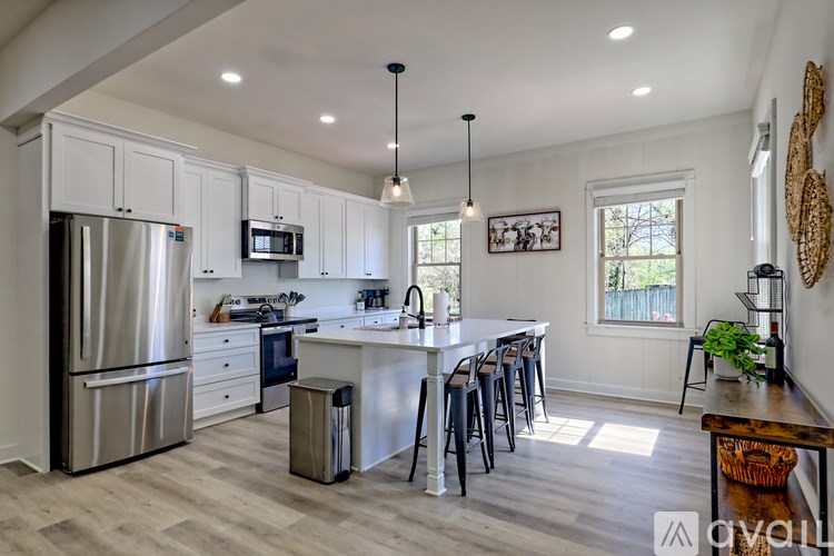 A kitchen with a refrigerator, stove, and oven.