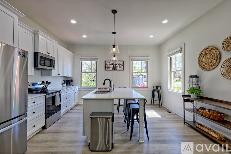 A kitchen with a large island and a dining table.