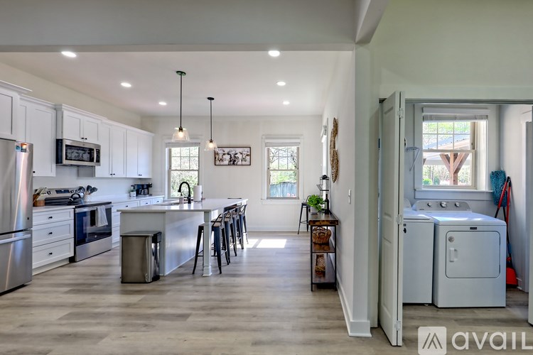 A kitchen with a refrigerator, oven, and microwave.