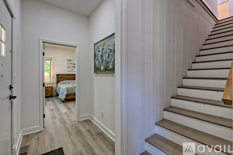 A staircase with wooden steps and a brown handrail.