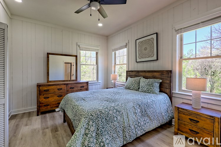 A bedroom with a bed, dresser, and mirror.