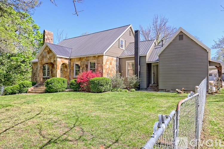 A house with a grey roof and a grey garage.
