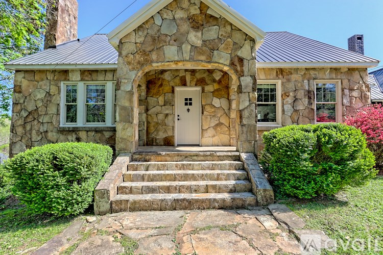 A house with a stone facade and a brown door.