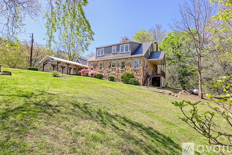 A house with a large lawn in front of it.