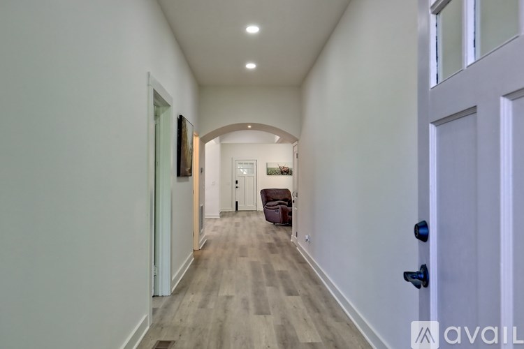 A long hallway with a door on the right.