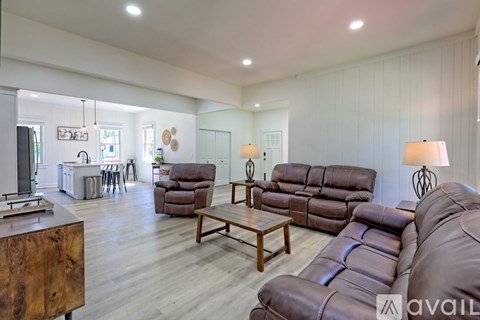 A living room with brown leather couches and a wooden coffee table.