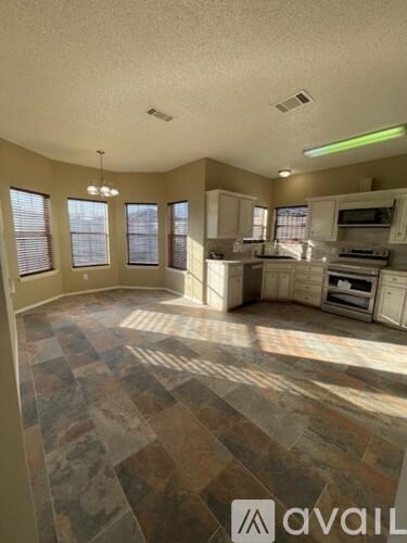 A kitchen with tile flooring and a large island.