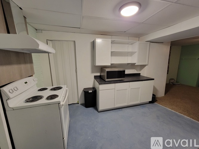 A small kitchen with a stove, oven, and microwave.