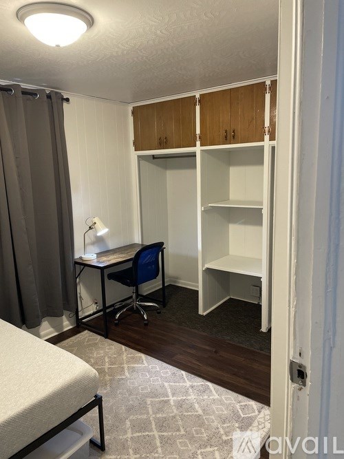 A small room with a desk and a bed.