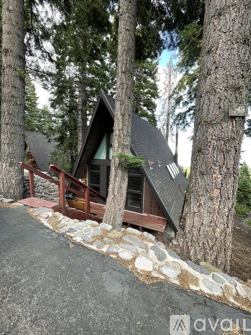 A small cabin is nestled in the woods.