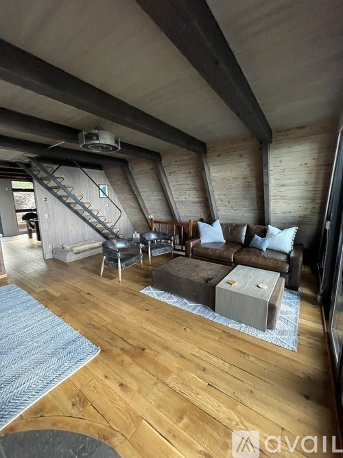 A living room with wooden floors and furniture.