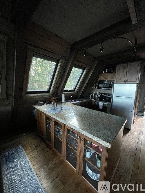 A kitchen with wooden cabinets and a granite countertop.
