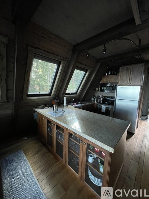 A kitchen with wooden cabinets and a granite countertop.