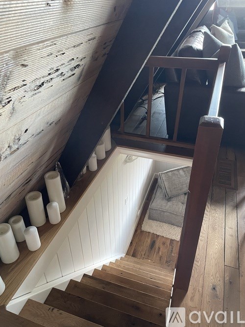 A staircase with wooden steps and a metal railing.