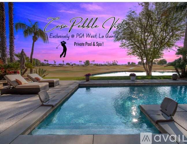 A poolside lounge area with a view of a golf course at dusk.