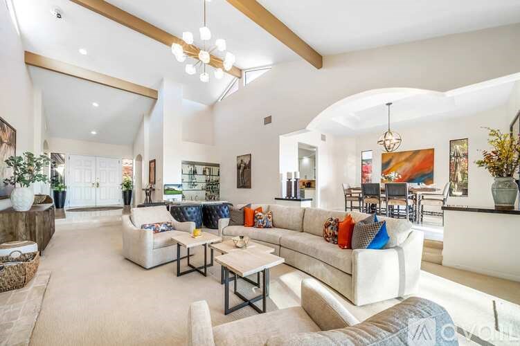 A living room with a white couch and a coffee table.