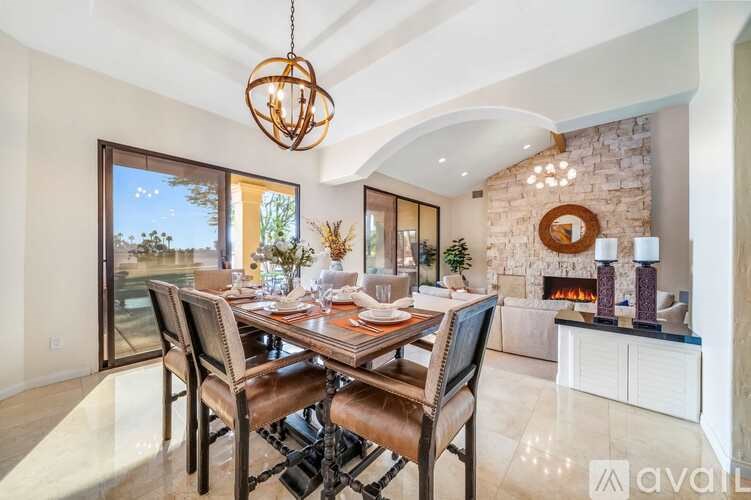A dining room with a wooden table and chairs.