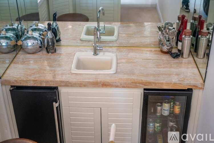 A kitchen with a sink and a refrigerator.