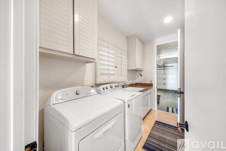 A small laundry room with a washer and dryer.
