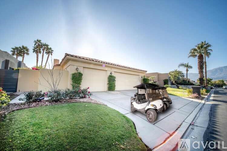 A house with a golf cart parked in front.