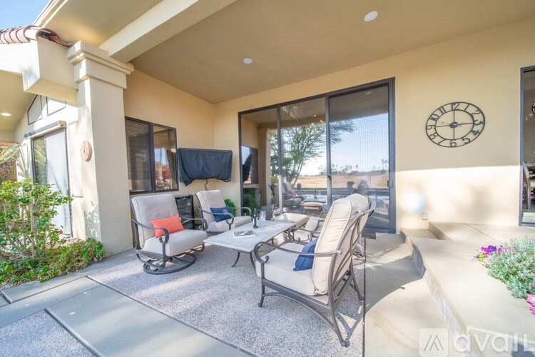 A patio with a couch, chairs, and a table is shown.