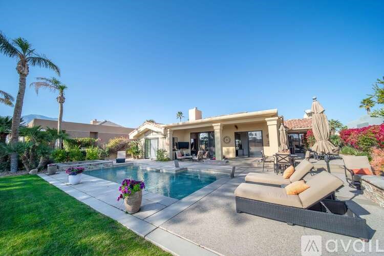 A large house with a pool in the backyard.