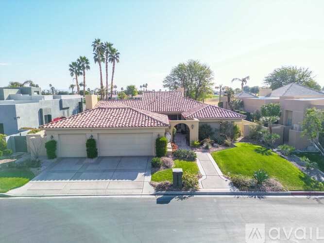 A house with a red tile roof is for sale.
