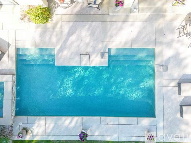 A rectangular pool with a white tile border.