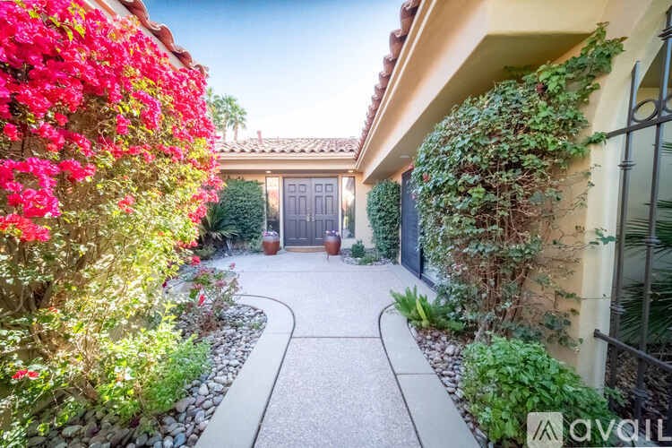 A house with a garden and a gate in the front.
