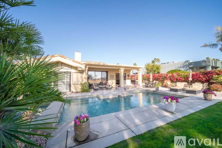 A house with a pool in the backyard.