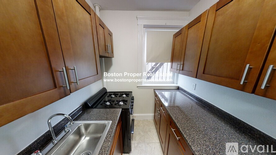 A kitchen with wooden cabinets and a stove top oven.