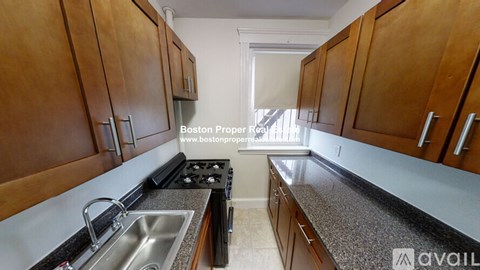 A kitchen with wooden cabinets and a stove top oven.