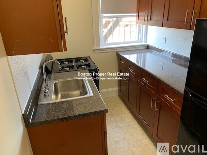 A kitchen with a stove top oven and sink.