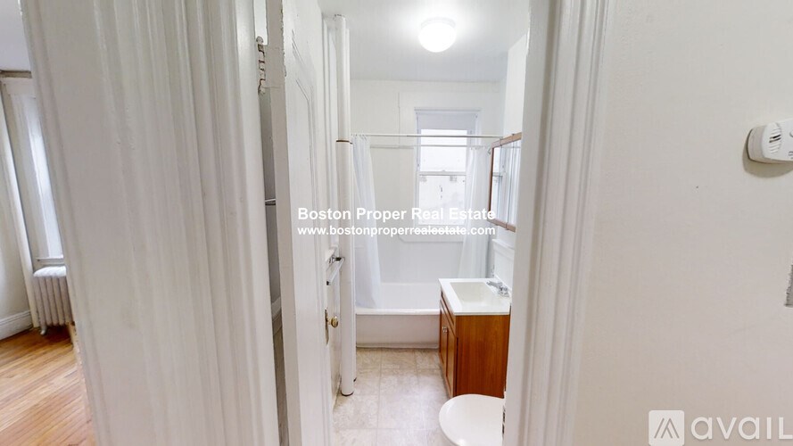 A white bathroom with a toilet and sink.
