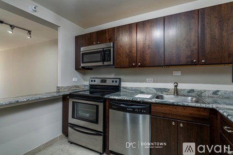 A kitchen with wooden cabinets and stainless steel appliances.