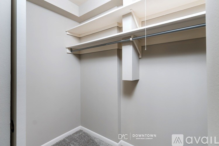 A white wall with a shelf and a sign that says "DC DOWNTOWN".