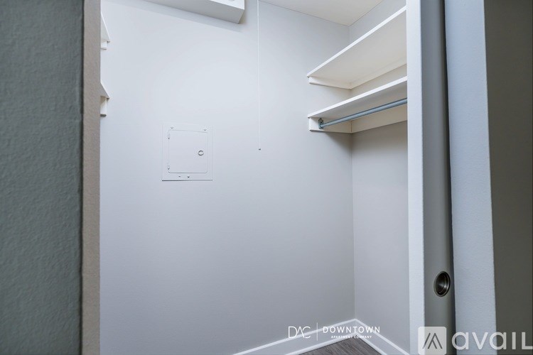 A white door with a handle and a small square on the wall.