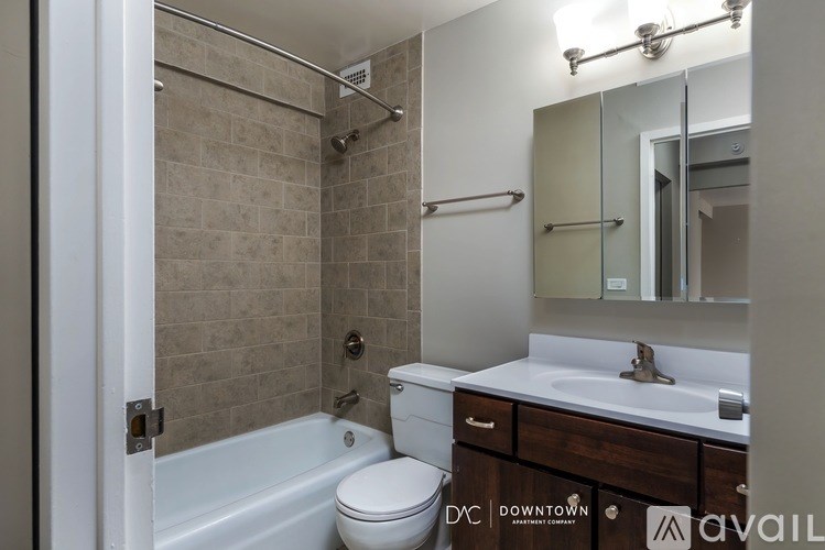 A bathroom with a toilet, sink, and bathtub.