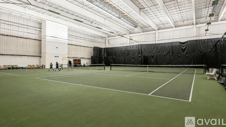 Tennis court with people playing tennis.
