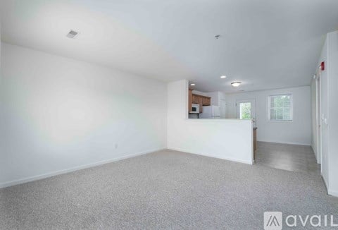 A kitchen with dark wood floors and stainless steel appliances.