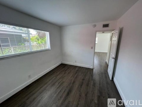 A white bathroom with a white shower curtain and a white shower head.