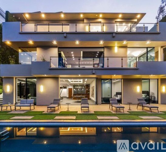 A modern house with a pool in the backyard.
