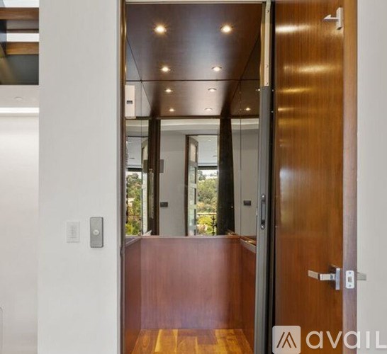A wooden door with a glass window and a handle.