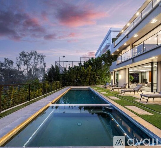 A modern house with a pool in the backyard.